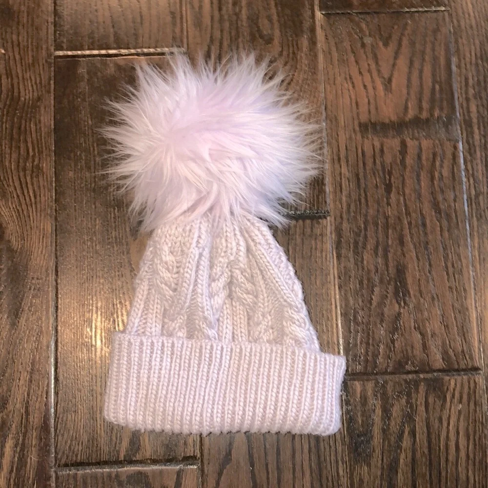The north face lavender color beanie hat with large fluff Pom Pom